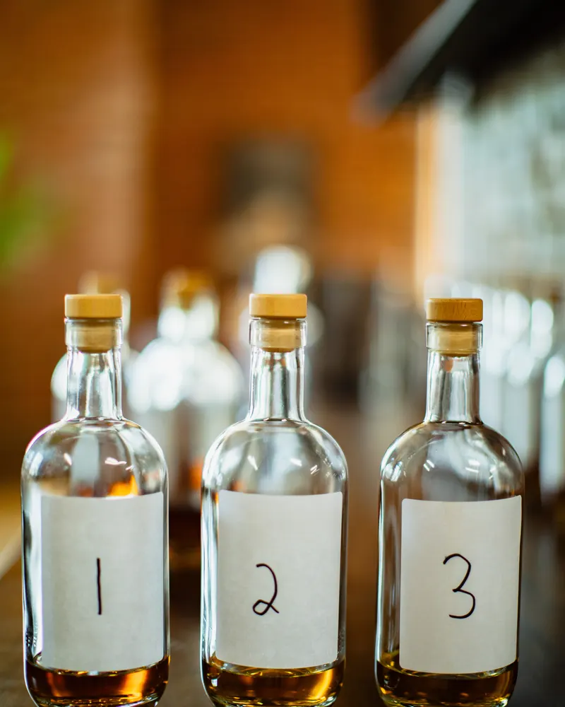 Three sample bottles numbered 1, 2 and 3, each a different shade of amber